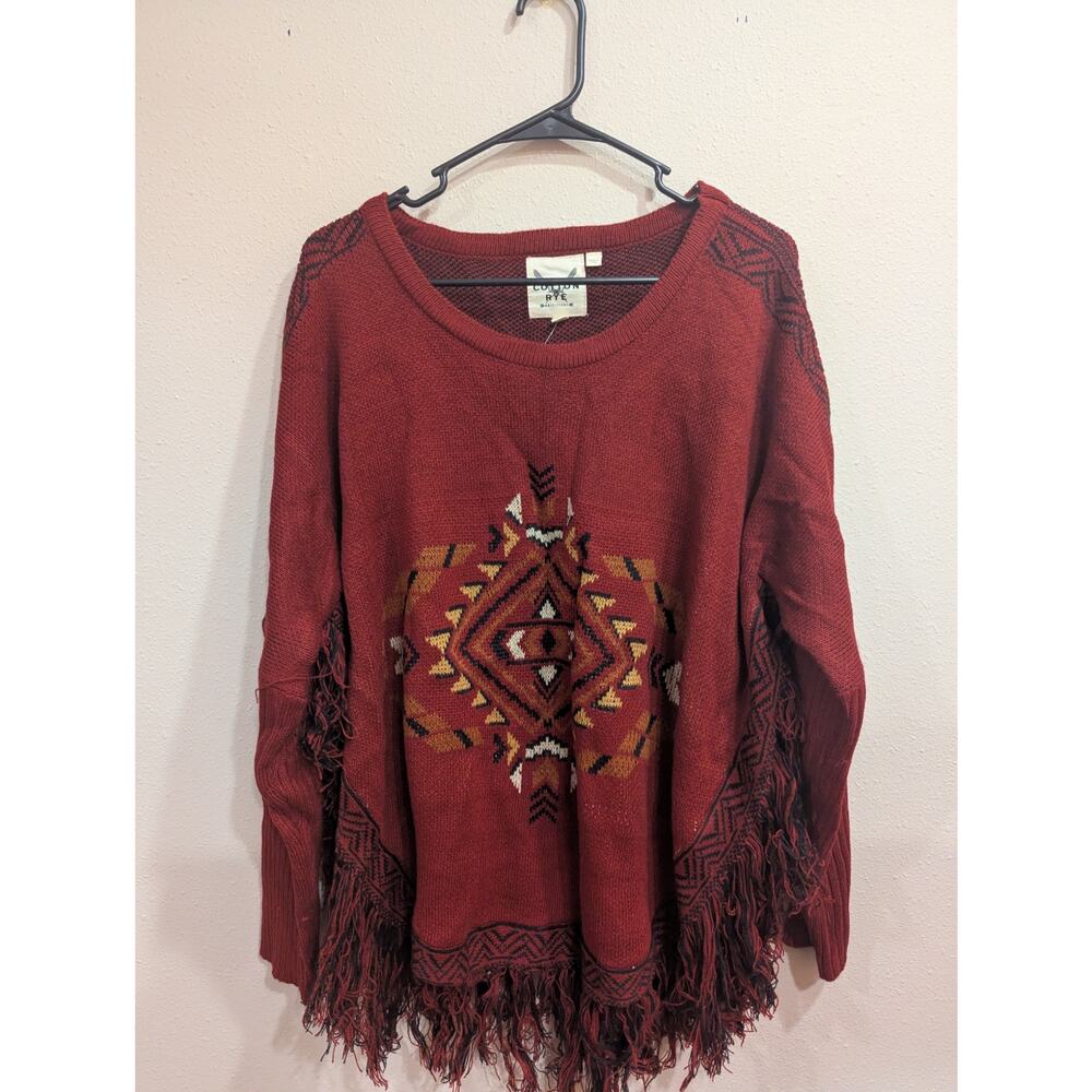 Southwestern style rust colored sweater with fringe detailing by Cotton & Rye